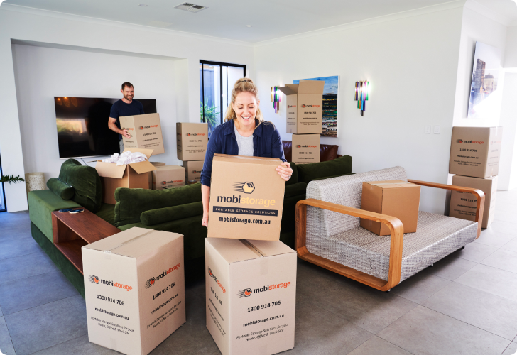 women and man with packing boxes inside home