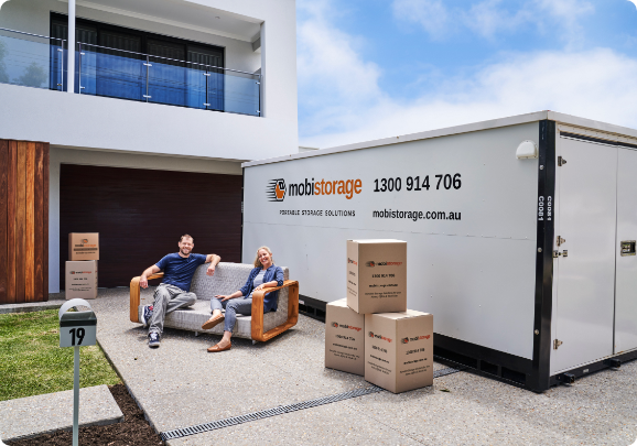 A couple finishing up loading their boxes inside a container