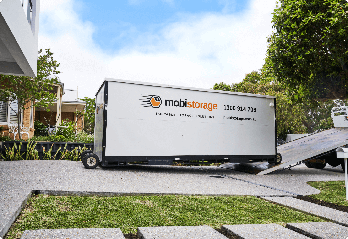 mobile storage container being loaded onto truck