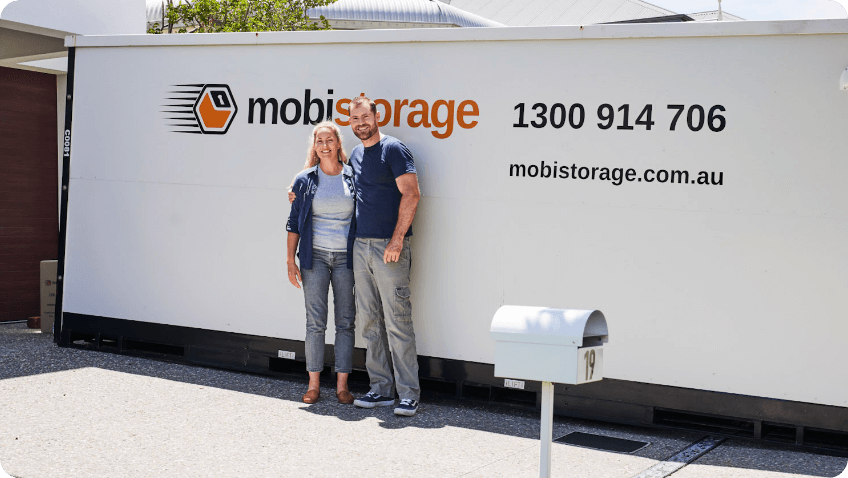 women and man standing in front of mobistorage container